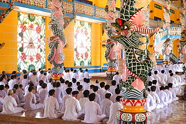 Praying devout men and women, ceremonial midday prayer, Cao Dai Holy See Temple, Tay Ninh, Vietnam, Indochina, Southeast Asia, Asia