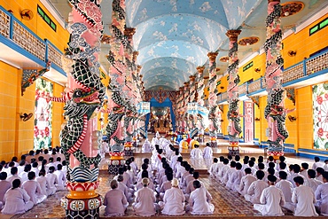 Praying devout men and women, ceremonial midday prayer, Cao Dai Holy See Temple, Tay Ninh, Vietnam, Indochina, Southeast Asia, Asia