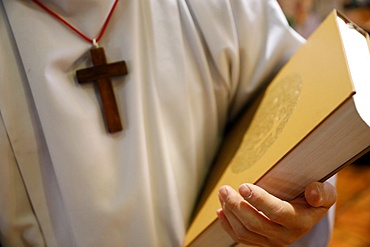 Altar boy with Holy Bible, Catholic Mass, Sallanches, Haute-Savoie, France, Europe