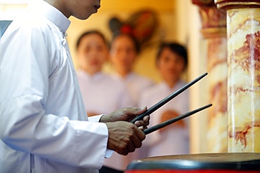 Cao Dai worshipper playing drums, Cao Dai Temple, Phu Quoc, Vietnam, Indochina, Southeast Asia, Asia