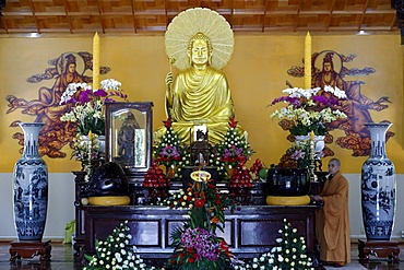 Main altar with Buddha statue and monk, Truc Lam Buddhist temple, Dalat, Vietnam, Indochina, Southeast Asia, Asia