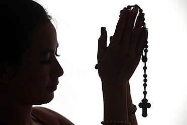 Christian woman praying the Rosary, Vietnam, Indochina, Asia