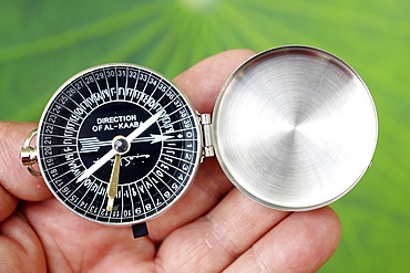 Close-up of a Muslim using a Qibla compass to indicate the direction of Al Kaaba, Cambodia, Indochina, Southeast Asia, Asia