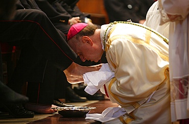 Bishop kissing feet after washing them, Easter Thursday Mass in St. Peter's Basilica, Vatican, Rome, Lazio, Italy, Europe