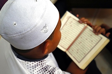 Muslim boy learning Quran at Islamic school, with Kufi hat, Ho Chi Minh City, Vietnam, Indochina, Southeast Asia, Asia