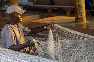 Fisherman mending nets in Fadiouth, Senegal, West Africa, Africa