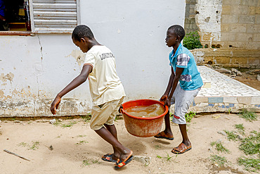 Boys fetching water in Thiaoune, Senegal, West Africa, Africa