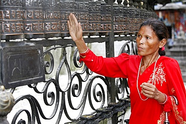 Woman and prayer wheels, Swayambhunath Temple, Kathmandu, Nepal, Asia