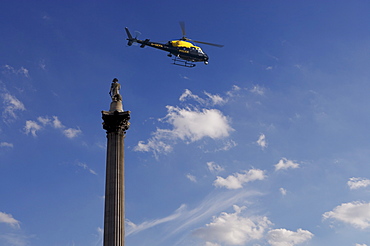 Nelsons Column and police helicopter, London, England, United Kingdom, Europe