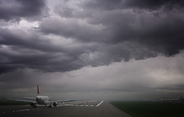 Plane ready for take off and stormy skies, Heathrow Airport, London, England, United Kingdom, Europe