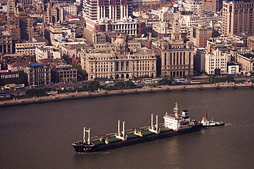 Bund and cargo ship on the Huangpu River, Shanghai, China, Asia