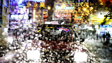 Taxis and traffic with neon signs through water droplets on screen, Hong Kong, China, Asia