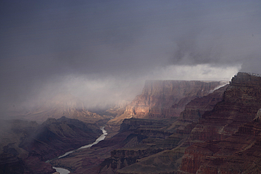 Grand Canyon, Colorado River, Geological Strata, Low Clouds, Dramatic Sky, Snow Capped Peaks, Arizona, USA.