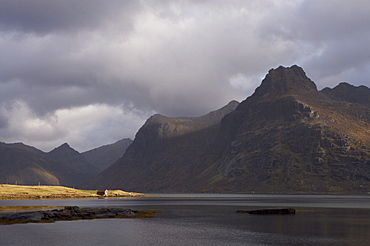 Red hut on bank of Fjord, Lofoten Islands, Norway, Scandinavia, Europe