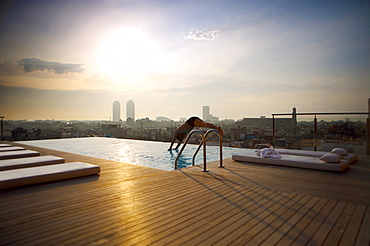 Man diving into rooftop pool, Barcelona, Catalonia, Spain, Europe