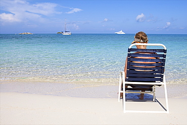 Tourist on the beach of Fernandez on Cat Island, Bahamas, West Indies, Caribbean, Central America