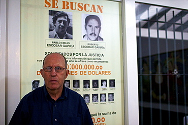 Roberto Escobar in his home of Medellin, under the panel offering 2 millions American dollars for his own capture, Colombia, South America