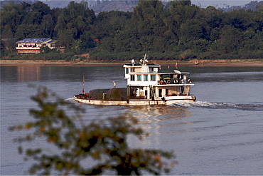 A small cargo boat on the Mekong River, in the northern area around Sop Ruak and the Laos and Burma borders, Thailand, Southeast Asia, Asia