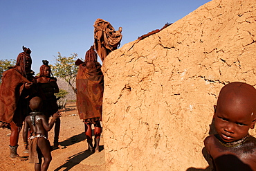 A Himba family in a village on the Kunene River, close to Epupa falls, on the border with Angola, Namibia, Africa