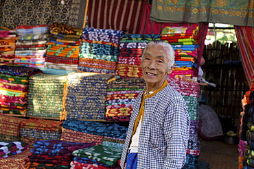 A woman selling blankets on the market of Bagan, Myanmar, Burma