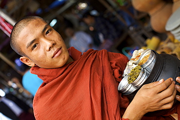 A young monk asking for food at the Bagan market, Bagan, Myanmar (Burma), Asia