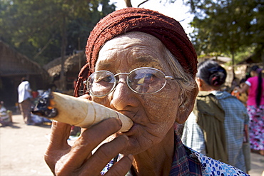 Old woman smoking a cigar, at the market of Bagan, Myanmar (Burma), Asia