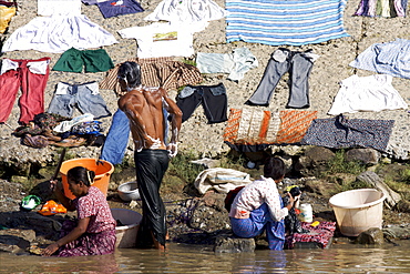 People washing on the edge of the Irrawaddy river in the area of Mandalay, Myanmar (Burma), Asia