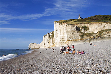 The great pebble beach of Etretat and the chapel of Notre-Dame de la Garde on the cliffs above, Etretat, Seine Maritime, Normandy, France, Europe