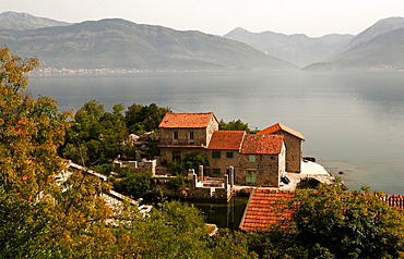 Typical houses with tiled roofs and stone walls on the Gulf of Kotor, Montenegro, Europe