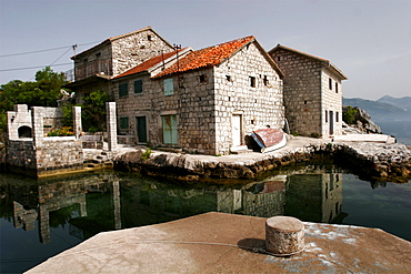 Typical houses with tiled roofs and stone walls on the Gulf of Kotor, Montenegro, Europe