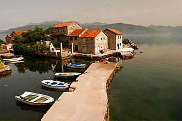 Typical houses with tiled roofs and stone walls on the Gulf of Kotor, Montenegro, Europe