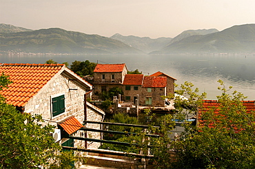 Typical houses with tiled roofs and stone walls on the Gulf of Kotor, Montenegro, Europe