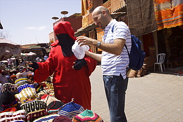 Tourist buying hat in Marrakech, Morocco, North Africa, Africa