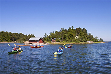 Canoeing along the coast of the Kobba Klintar island in the Aland archipelago, Finland, Scandinavia, Europe