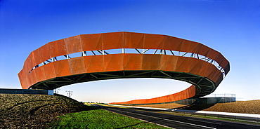 Arching rusting Corten steel footbridge, Craigieburn Bypass, Melbourne, Victoria, Australia, Pacific