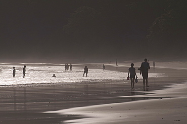 People walking along the wonderful Elephanta Beach in the dusk, Havelock Island, Andaman Islands, India, Indian Ocean, Asia