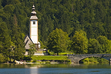 Church in village, bridge over Bohinj Lake, Slovenia, Europe