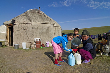 Family in front of their yurt, Song Kul, Kyrgyzstan, Central Asia, Asia