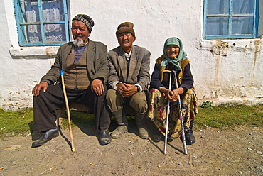 Three oldies sitting on a bench and having a chat, At Bashy, Kyrgyzstan, Central Asia, Asia