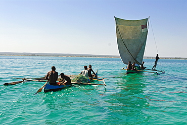 Traditional sailing boat and rowing boat in the turquoise water of the Indian Ocean, Madagascar, Africa