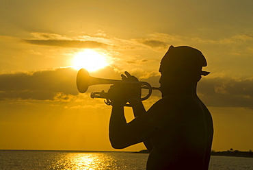 Trumpet player at sunset, Playa Ancon, Trinidad, Cuba, West Indies, Caribbean, Central America