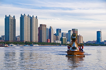 The Songhua River in front of modern office blocks  in the most northern town of Harbin, Dongbei (Manchuria), China, Asia