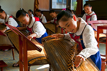 Young girls playing traditional instruments in the Schoolchildrens palace, Pyongyang, North Korea, Asia