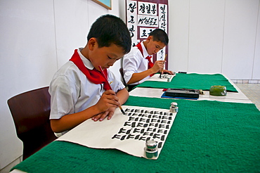 Young boys practising calligraphy in the Schoolchildrens palace, Pyongyang, North Korea, Asia