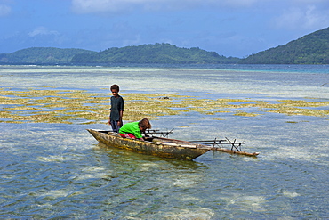 Young boys fishing near Samarai, the old capital, Papua New Guinea, Pacific