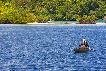 Man sitting in his canoe, Marovo Lagoon, Solomon Islands, Pacific