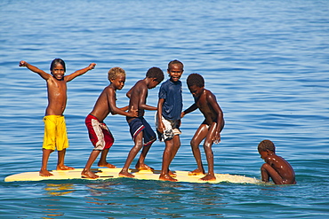 Happy children playing on the beach of Savo island, Solomon Islands, Pacific