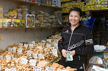 Friendly woman selling biscuits at a market stand, Alma Ata, Kazakhstan, Central Asia, Asia