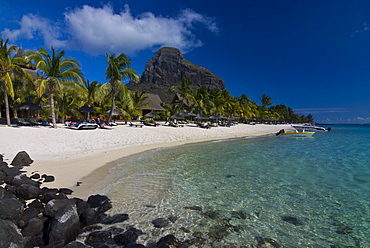 Sun loungers on the beach and Mont Brabant (Le Morne Brabant), UNESCO World Heritage Site, Mauritius, Indian Ocean