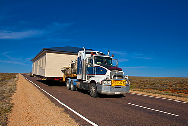 Truck transporting a full house on its trailer in the Outback of South Australia, Australia, Pacific